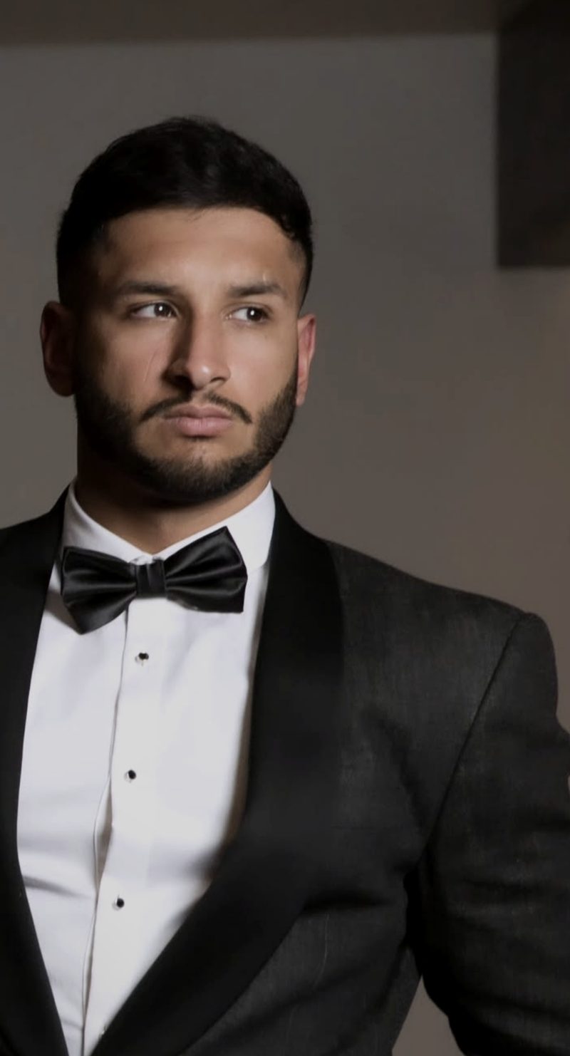 Portrait of DJ Jeevz in a black tie tuxedo