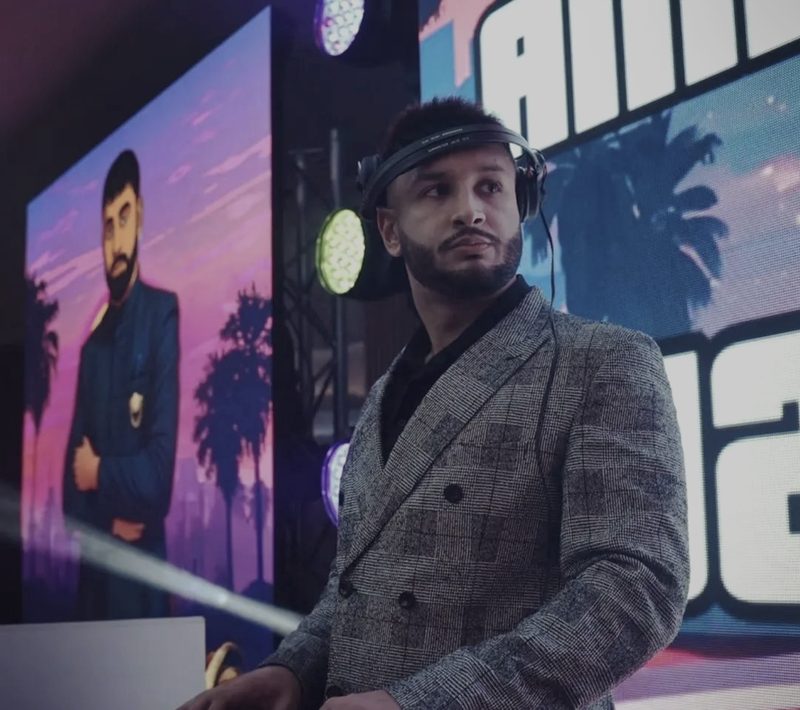 DJ Jeevz performing on stage in front of LED screens